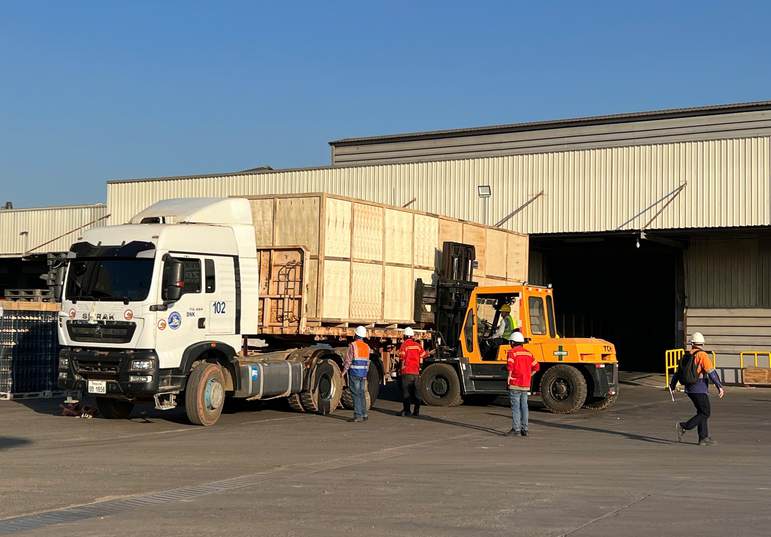 Loading crated cargo onto a truck, iSolution Logistics